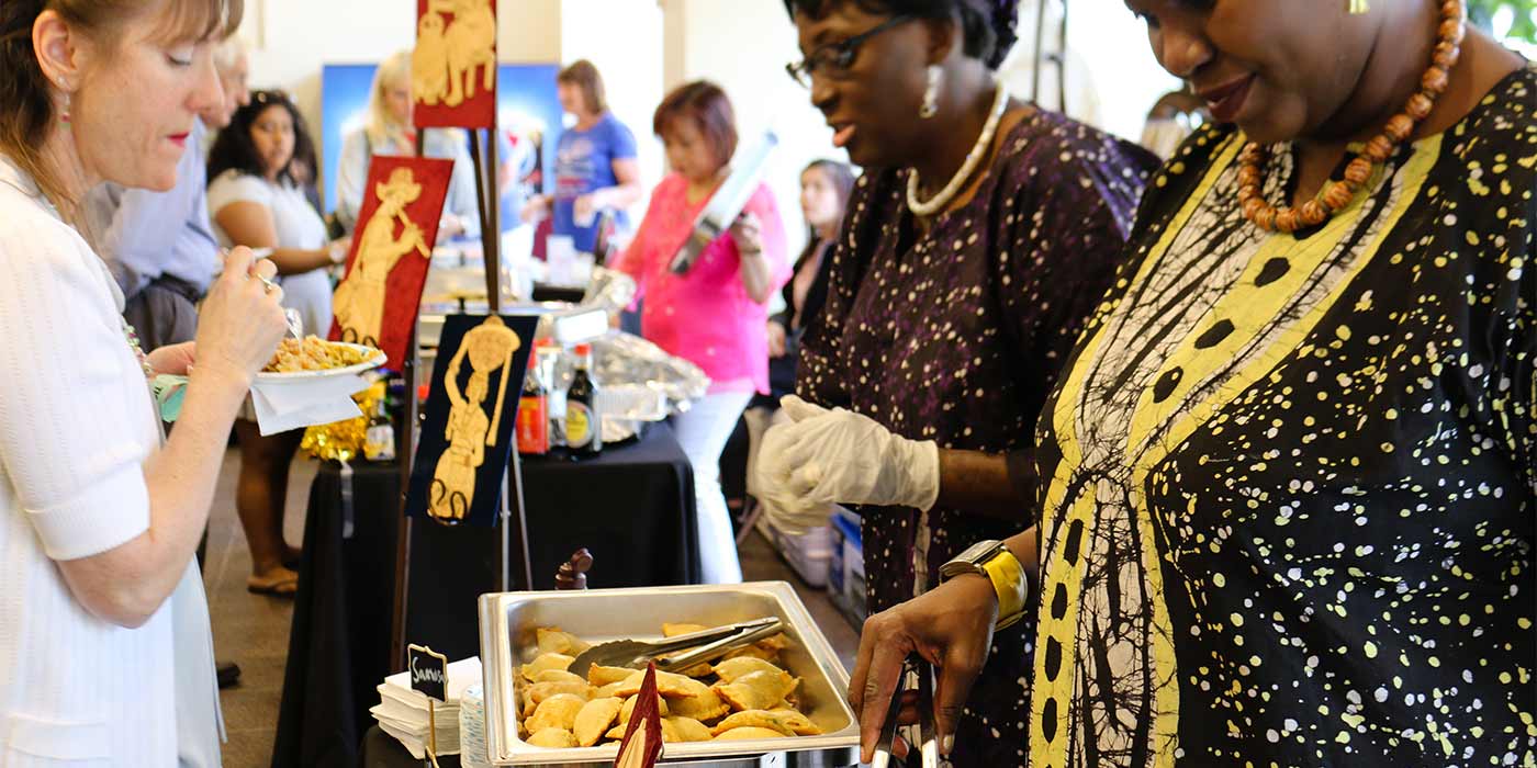 Women serving food at a buffet